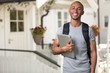© BillionPhotos.com - Smiling student man with laptop on house background