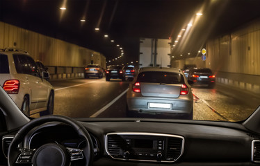 Wall Mural - view from the car through the windshield of traffic in a tunnel