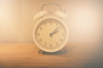 Alarm clock on the wood table beside the bed