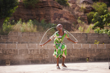 little african girl enjoying herself with her skipping rope