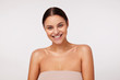 © timtimphoto - Cheerful pretty young dark haired woman with charming green eyes showing her perfect white teeth while smiling widely to camera, standing against white background