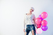 © dmitriisimakov - blonde woman with balloons and gift for holiday