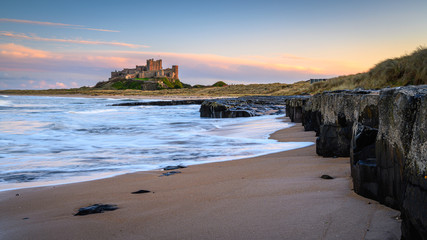 Canvas Print - Small Cliffs at Bamburgh Beach, and dunes which are dominated by the imposing medieval castle and located within Northumberland Coast Area of Outstanding Natural Beauty