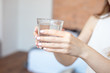 © Viktoria - Female hands holding a clear glass of water.A glass of clean mineral water in hands, healthy drink