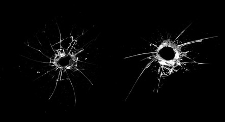 Poster - hole in the glass with cracks isolated on a black background