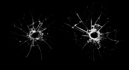 Poster - hole in the glass with cracks isolated on a black background