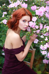 Wall Mural - beautiful red-haired girl in arranger where azalea blooms in a colorful flying dress