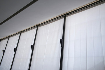 Poster - Vertical louvers on windows. Semitransparent curtains as modern interior design in minimal style. Abstract office or home architecture background with geometric composition viewed in perspective.