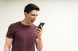 © AntonioDiaz - Furious Man Screaming Over Mobile Phone In Studio