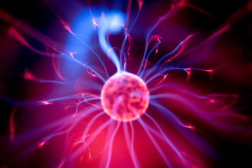 decoration lamp in shape of plasma ball with red and blue electrodes, close-up
