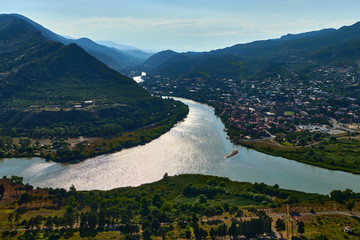 An amazing view of the confluence of the two rivers .  Landscape with mountains . 