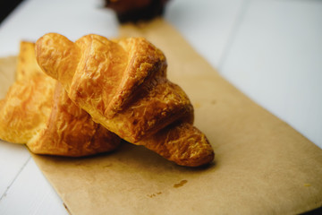 two fresh croissants on white background