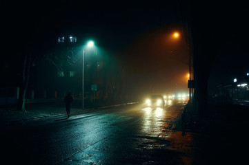 fog in the night city after rain, car headlights