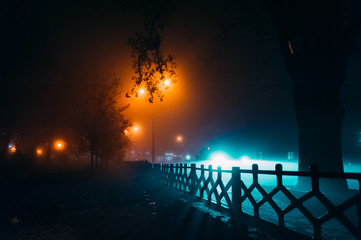 fog in the night city after rain, car headlights