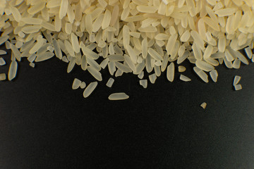 Poster - long white polished rice on a black background