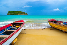 Colorful Old Wooden Fishing Boats Docked By Water On A Beautiful Beach Coast Land. White Sand Sea Shore Landscape On Tropical Caribbean Island. Holiday Weekend/ Summer Vacation Setting In Jamaica.