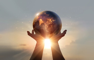Poster - Earth at night was holding in human hands. Earth day. Energy saving concept