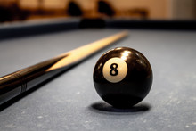 Billiard Ball Figure Eight On A Table With Cues.