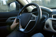 © bela_zamsha - male hands hold the wheel of a new car