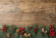Flat Lay Composition With Fir Branches And Berries On Wooden Background, Space For Text. Winter Holidays