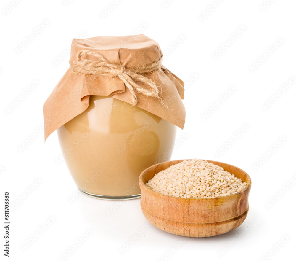 Jar of tasty tahini on white background