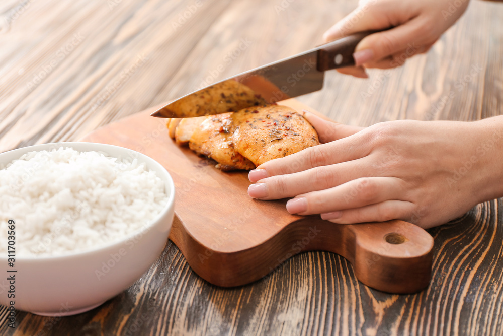 Woman preparing tasty rice with chicken