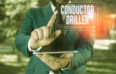 Poster - Text sign showing Conductor Driller. Business photo text means of conveying the upflowing drilling fluid Businessman in blue suite with a tie holds lap top in hands