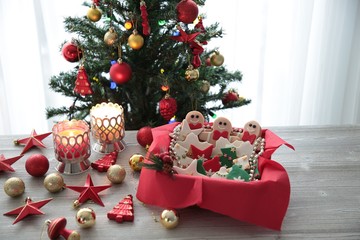 Plate with tasty Christmas cookies on wooden table