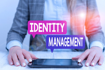 Fototapete - Word writing text Identity Management. Business photo showcasing administration of individual identities within a system Business woman sitting with mobile phone on the table