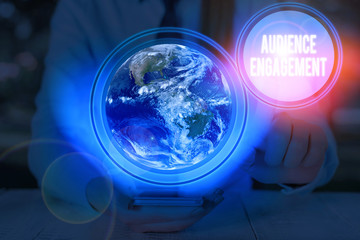 Poster - Writing note showing Audience Engagement. Business concept for active involvement of an audience in a live broadcast Elements of this image furnished by NASA