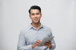 © makistock - Handsome young Asian man using pad on white background.
