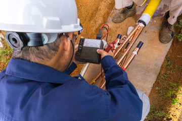 Worker doing cable underground splicing