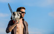 © be free - so hot. comfident worker. Mens power. macho man chain saw tool. men brutality and sexuality. Job for real men. sexy man sky background. male work power saw. He fix everything. copy space
