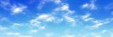 Fototapeta Na sufit - Colorful panoramic landscape: blue sky and fluffy clouds.  (Plane backplate, 3D rendering computer digitally generated illustration.)