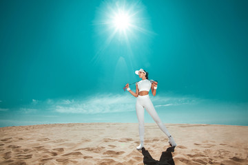 Sticker - Sporty and fit woman athlete doing training with jump rope on the sky background. The concept of a healthy lifestyle and sport. Individual sports recreation.