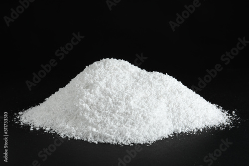 Cuadros en Lienzo Heap of white snow on black background