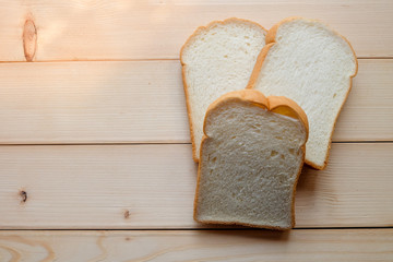 Top view and close up: slice of bread on wooden background. Breakfast concept.	