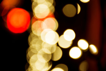 Abstract blurred defocused red and yellow bokeh lights glowing in the dark at night