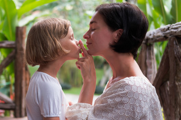 Mom and daughter emotional photo. Green background.