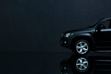 The Front Of A Model Copy Of The Amarok On A Black Background And Reflective Surface.