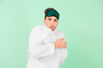 Poster - Handsome man in bathrobe and sleep mask on color background