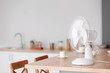 Electric fan on table in kitchen