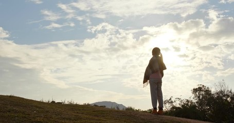 Canvas Print - Woman look at the view at sunset time in countryside