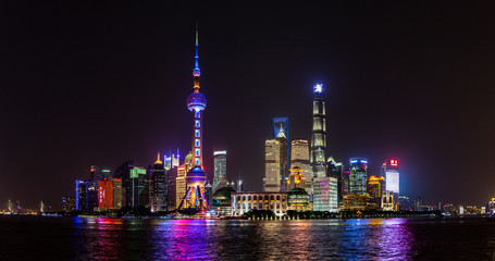 Panoramic picture of skyscrapers of Pudong district from the Bund in Shanghai at night in winter