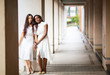 © FotoArtist - portrait of Asian and African american women in white dress against street