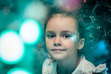Wall Mural - girl with a snowflake on her cheek