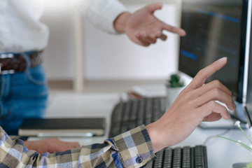 young startup programmers sitting at desks working on computers screen for developing programming an