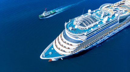 Wall Mural - Aerial view of beautiful white cruise ship above luxury cruise running with tug boat in the ocean sea  concept tourism travel on holiday take a vacation time on summer.  forwarder mast