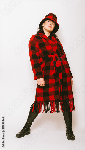 Αφίσα Studio portrait of beautiful woman wearing checked red and black coat and a hat,