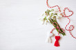 Bouquet of snowdrops and red white hearts on a wooden background for congratulations, holiday Martisor, Baba Marta